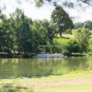 The green pavilion at Bowl Lake stands in the shade of trees on the edge of the lake shoreline